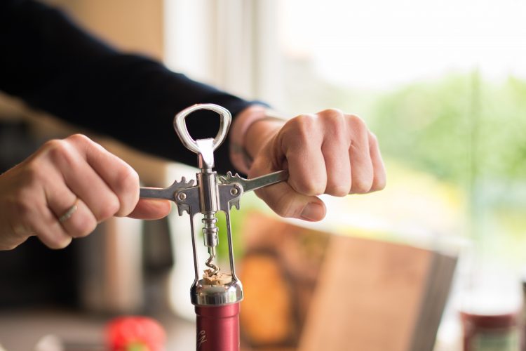 person opening wine