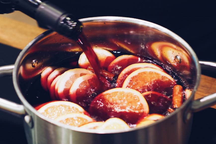 Pot with oranges and wine