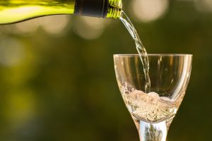 White wine pouring into a glass