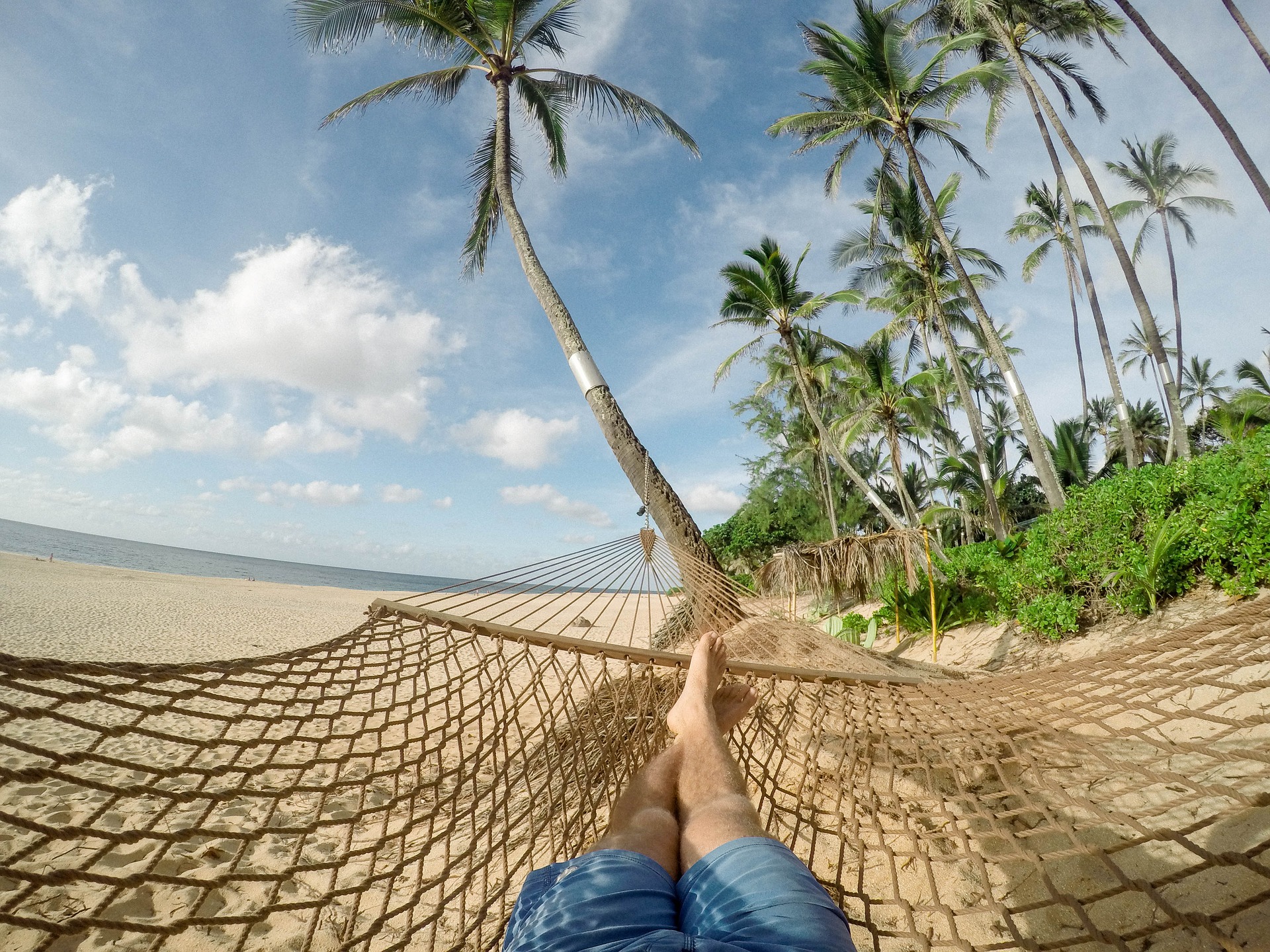 Woman laying in a hammock on the beach