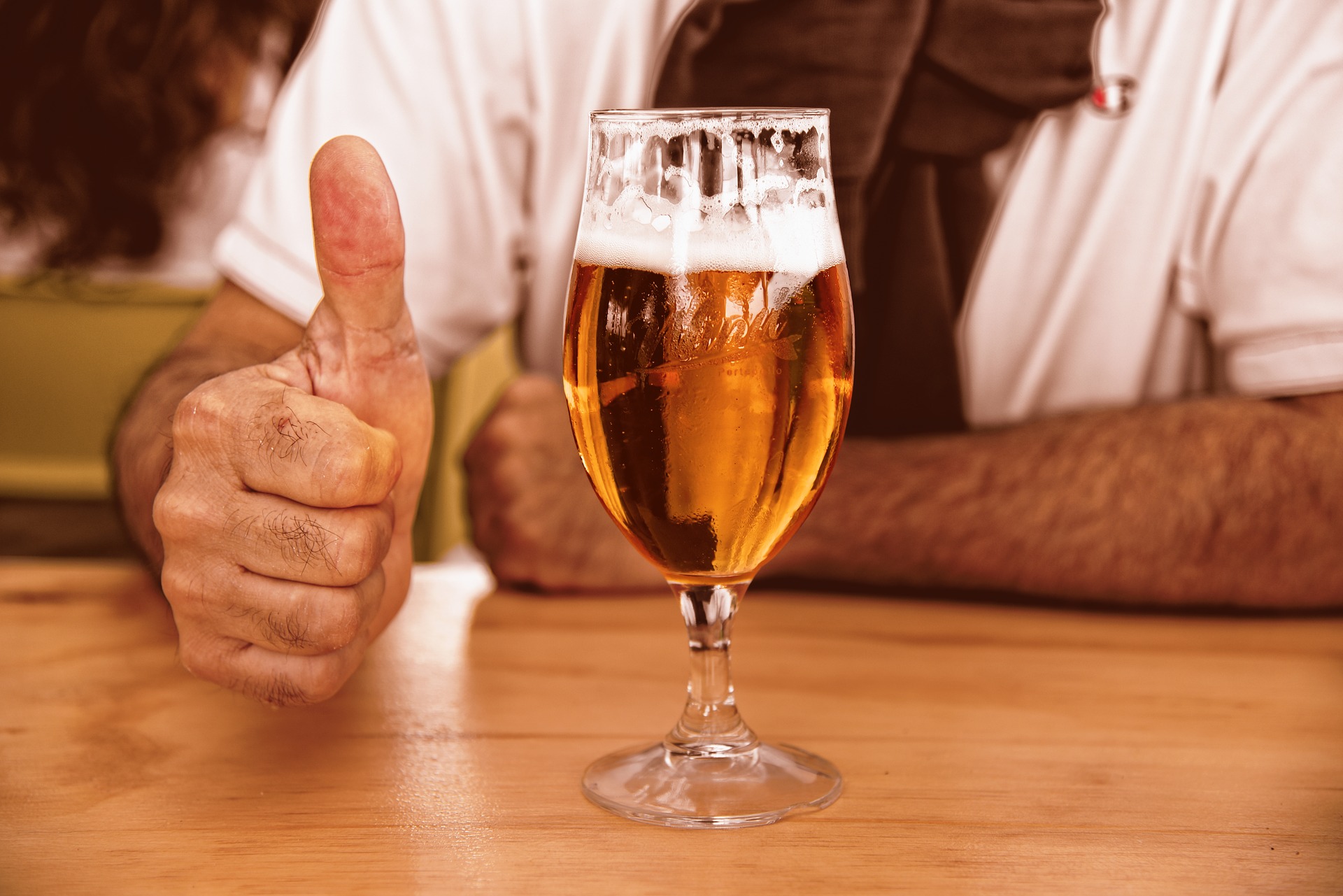 Glass of beer with thumbs up